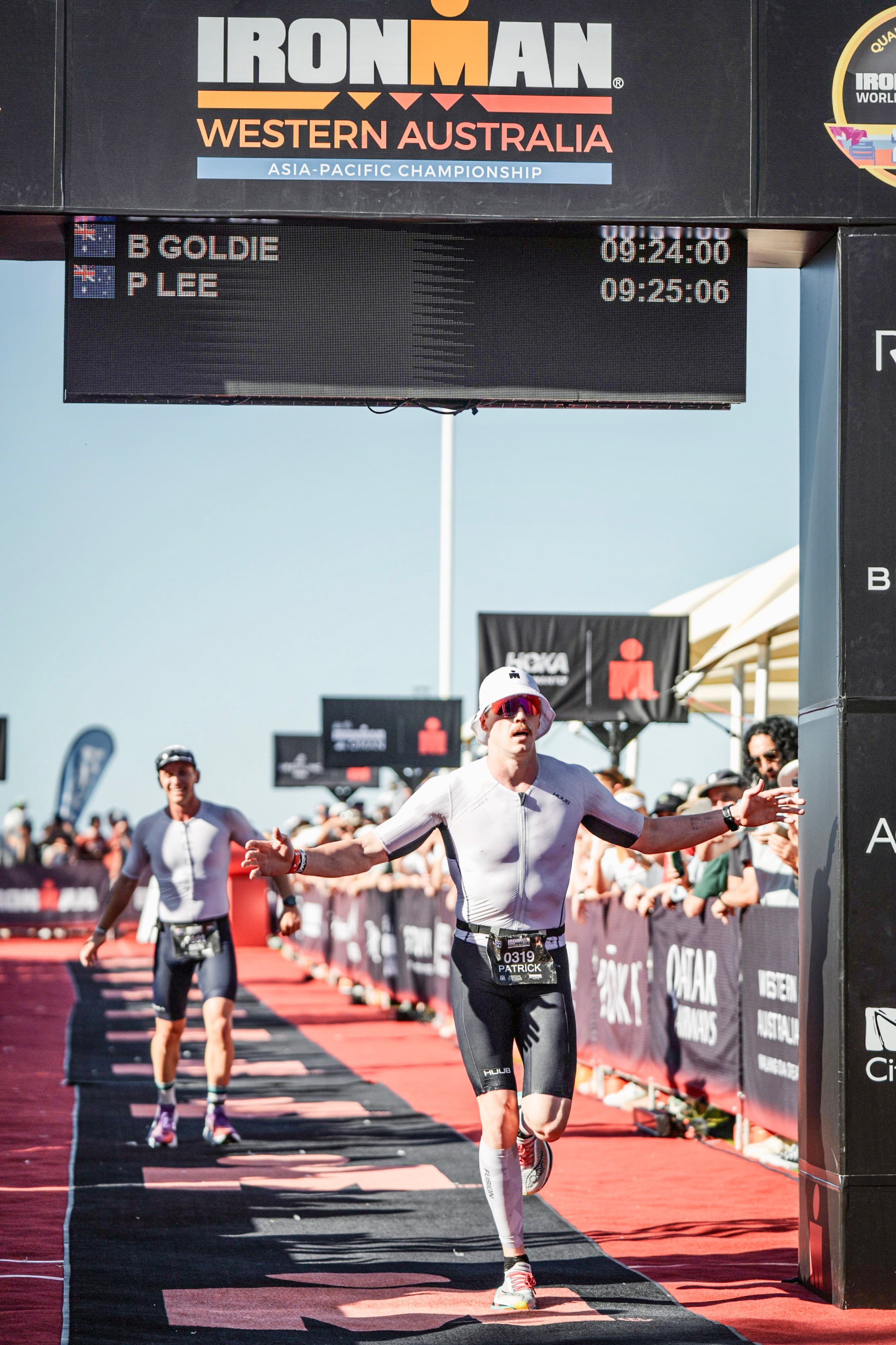 Patrick Lee crossing the Ironman Busselton finish line